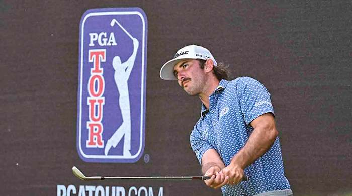 Max Homa chips a shot next to PGA Tour signage during the 2022 Arnold Palmer Invitational presented by MasterCard at Bay Hill Club and Lodge in Orlando, Fla.